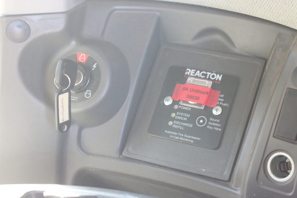Reacton firefighting system control panel with Unitruck SIA identification marking CLASS Lexion 660 in the cab.